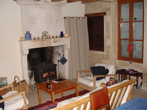 Main downstairs room: fire, book, bottle of cognac